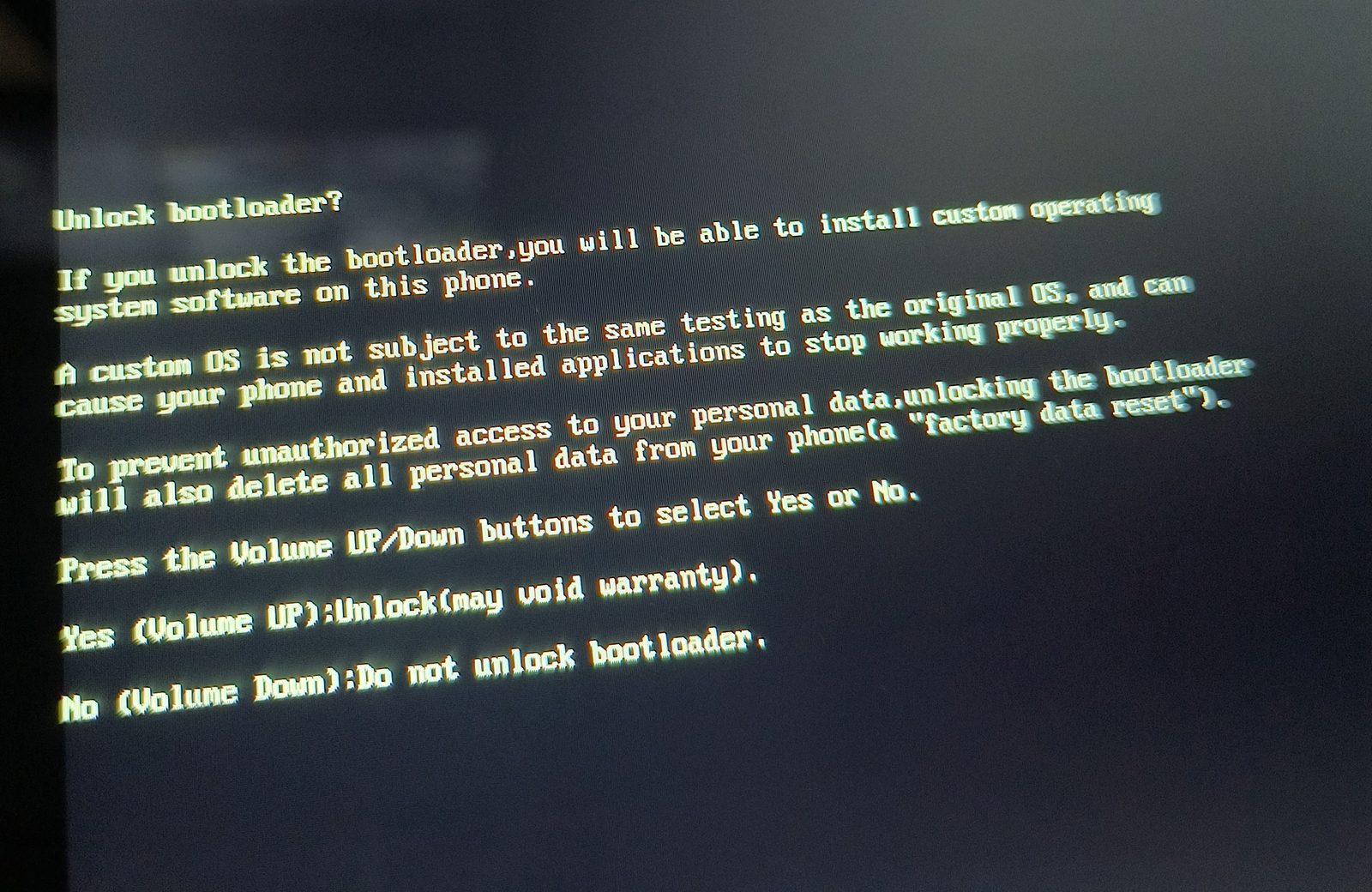 The on-device unlock warning: red text, volume-key confirmation, and the word "phone" on an 8-inch tablet